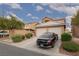 Inviting two-story home with a two-car garage, desert landscaping, and a private driveway at 8008 Draco Cir # 201, Las Vegas, NV 89128