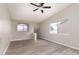 Spacious living room with wood floors, ceiling fan, and staircase at 8008 Draco Cir # 201, Las Vegas, NV 89128