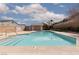 Community swimming pool with blue water and surrounding patio at 8008 Draco Cir # 201, Las Vegas, NV 89128