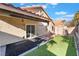 Backyard featuring artificial grass, pavers, string lights, and shed at 8113 Dolphin Landing Dr, Las Vegas, NV 89128