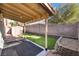 Backyard featuring artificial grass, shed, and covered patio at 8113 Dolphin Landing Dr, Las Vegas, NV 89128