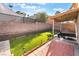 Backyard featuring artificial grass, pavers, and retaining wall at 8113 Dolphin Landing Dr, Las Vegas, NV 89128