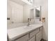 Bright bathroom featuring a white vanity, sink, mirror, and cabinet storage at 8113 Dolphin Landing Dr, Las Vegas, NV 89128