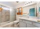 Bathroom featuring a shower with glass doors, white vanity, and wooden cabinet at 8113 Dolphin Landing Dr, Las Vegas, NV 89128