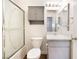 Bright bathroom featuring a shower with glass doors, gray vanity, and decorative cabinet at 8113 Dolphin Landing Dr, Las Vegas, NV 89128