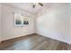 Cozy bedroom with wood-look floors, a window, and natural light at 8113 Dolphin Landing Dr, Las Vegas, NV 89128