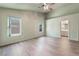 Bedroom featuring wood-look floors, natural light, and an ensuite bathroom at 8113 Dolphin Landing Dr, Las Vegas, NV 89128
