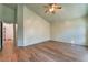 Large bedroom featuring wood-look floors, light walls, and a ceiling fan at 8113 Dolphin Landing Dr, Las Vegas, NV 89128