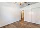Well-lit bedroom with a ceiling fan, double door closet, and an open doorway at 8113 Dolphin Landing Dr, Las Vegas, NV 89128