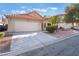 Single-story home featuring a spacious driveway, two-car garage, and low-maintenance desert landscaping at 8113 Dolphin Landing Dr, Las Vegas, NV 89128