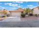 Inviting single-story home showcasing a two-car garage and low-maintenance desert landscaping at 8113 Dolphin Landing Dr, Las Vegas, NV 89128