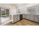 Well-lit kitchen featuring modern stainless steel appliances, white cabinetry, and sliding door access to the backyard at 8113 Dolphin Landing Dr, Las Vegas, NV 89128