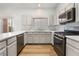 Modern kitchen featuring stainless steel appliances, white countertops, and ample cabinet space at 8113 Dolphin Landing Dr, Las Vegas, NV 89128