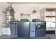 Bright laundry room with washer, dryer, water softener, and water heater at 8113 Dolphin Landing Dr, Las Vegas, NV 89128