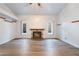 Bright, open living room features wood-look floors and a charming fireplace at 8113 Dolphin Landing Dr, Las Vegas, NV 89128