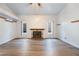 Bright, open living room features wood-look floors and a charming fireplace at 8113 Dolphin Landing Dr, Las Vegas, NV 89128