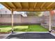 Covered patio with string lights overlooking the backyard at 8113 Dolphin Landing Dr, Las Vegas, NV 89128