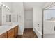 Clean bathroom with dual sinks, wood cabinets, and a separate tub and shower at 820 Wintersweet Rd, Henderson, NV 89015