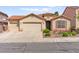 Charming single-story home with a tile roof, three-car garage, and desert landscaping at 820 Wintersweet Rd, Henderson, NV 89015