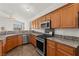 Well-lit kitchen boasts stainless-steel appliances and granite countertops at 820 Wintersweet Rd, Henderson, NV 89015