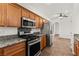 Kitchen with stainless-steel appliances and wood cabinetry at 820 Wintersweet Rd, Henderson, NV 89015