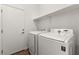 Bright laundry room with modern appliances and built-in shelving for storage at 820 Wintersweet Rd, Henderson, NV 89015