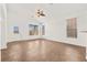 Bright living room with a ceiling fan, tile flooring, and expansive windows for natural light at 820 Wintersweet Rd, Henderson, NV 89015