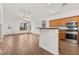 Open living space with tile flooring, leading to a kitchen with oak cabinets and modern appliances at 820 Wintersweet Rd, Henderson, NV 89015