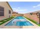Beautiful in-ground pool and spa with artificial turf and concrete tile border at 820 Wintersweet Rd, Henderson, NV 89015