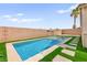 Beautiful swimming pool featuring artificial turf and well-maintained backyard at 820 Wintersweet Rd, Henderson, NV 89015