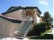 Two-story apartment building with terracotta roof and direct entry via stairway in Las Vegas, Nevada at 8410 Eldora Ave # 2067, Las Vegas, NV 89117