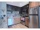 Modern kitchen featuring stainless steel appliances, wood cabinets, and tile backsplash at 8410 Eldora Ave # 2067, Las Vegas, NV 89117