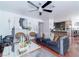 Open-concept living room with sleek ceiling fan, comfortable seating, and wood flooring at 8410 Eldora Ave # 2067, Las Vegas, NV 89117