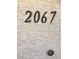 Close-up of the unit's street number '2067' affixed to the exterior wall at 8410 Eldora Ave # 2067, Las Vegas, NV 89117