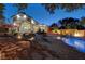 Outdoor oasis with gorgeous pool and manicured landscaping enhanced by landscape lighting at 8470 S Pioneer Way, Las Vegas, NV 89113