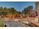 Beautiful backyard with accent lighting, mature trees, desert landscaping, and hardscape creating a serene outdoor space at 8470 S Pioneer Way, Las Vegas, NV 89113