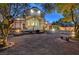 Lush backyard features desert landscaping and inviting exterior lighting, showcasing a cozy seating area with a bench at 8470 S Pioneer Way, Las Vegas, NV 89113