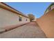 Spacious backyard with gravel, mature landscaping, and privacy wall at 8470 S Pioneer Way, Las Vegas, NV 89113