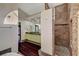 Well lit bathroom with tile shower, hard wood floors, and double sink vanity at 8470 S Pioneer Way, Las Vegas, NV 89113