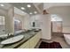 Spa-like bathroom with double vanity, stone shower, and a soaking tub at 8470 S Pioneer Way, Las Vegas, NV 89113