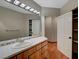 Bathroom showcasing tile floors, a single sink vanity and ample shelving at 8470 S Pioneer Way, Las Vegas, NV 89113