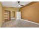 Bright bedroom with fan, closet with shelving, and tiled flooring at 8470 S Pioneer Way, Las Vegas, NV 89113