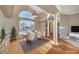 Elegant dining room featuring hardwood floors, high ceilings, and a large arched window at 8470 S Pioneer Way, Las Vegas, NV 89113