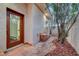 Charming front entrance with tiled walkway, mature trees, and view into the home at 8470 S Pioneer Way, Las Vegas, NV 89113
