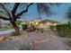 Inviting front yard with desert landscaping, stone accents, and mature trees at 8470 S Pioneer Way, Las Vegas, NV 89113