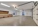 Spacious garage with concrete floor and lighting fixtures with room for workbench at 8470 S Pioneer Way, Las Vegas, NV 89113