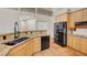 Kitchen with light wood cabinets, black appliances, and earth-toned countertops at 8470 S Pioneer Way, Las Vegas, NV 89113