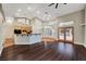 Open-concept living space with high ceilings, hardwood floors, and a bar leading to the kitchen at 8470 S Pioneer Way, Las Vegas, NV 89113