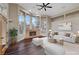 Cozy living room features hardwood floors, large windows, and a stone fireplace at 8470 S Pioneer Way, Las Vegas, NV 89113