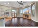 Spacious living room featuring dark hardwood floors, stone fireplace, and large windows at 8470 S Pioneer Way, Las Vegas, NV 89113